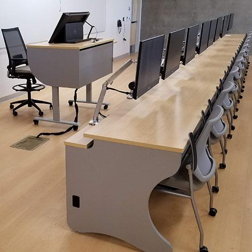 Split top desks with surface mount arms. 